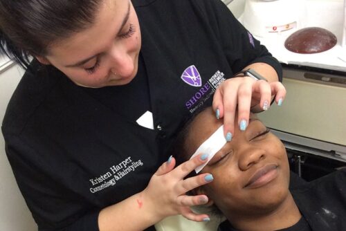Shore Cosmetology student practicing skills on client