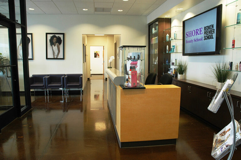Modern beauty school reception area with a bright, welcoming desk and stylish seating.