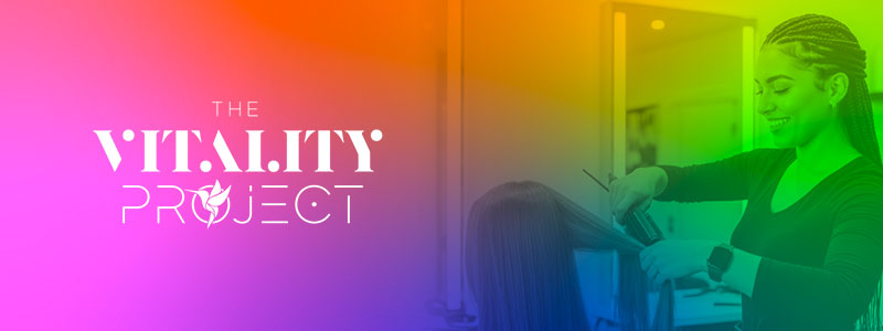 Colorful banner for The Vitality Project featuring a hairstylist working in a salon.
